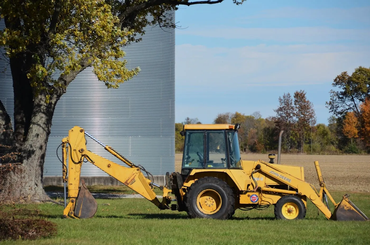 Yellow backhoe loader parked on a site