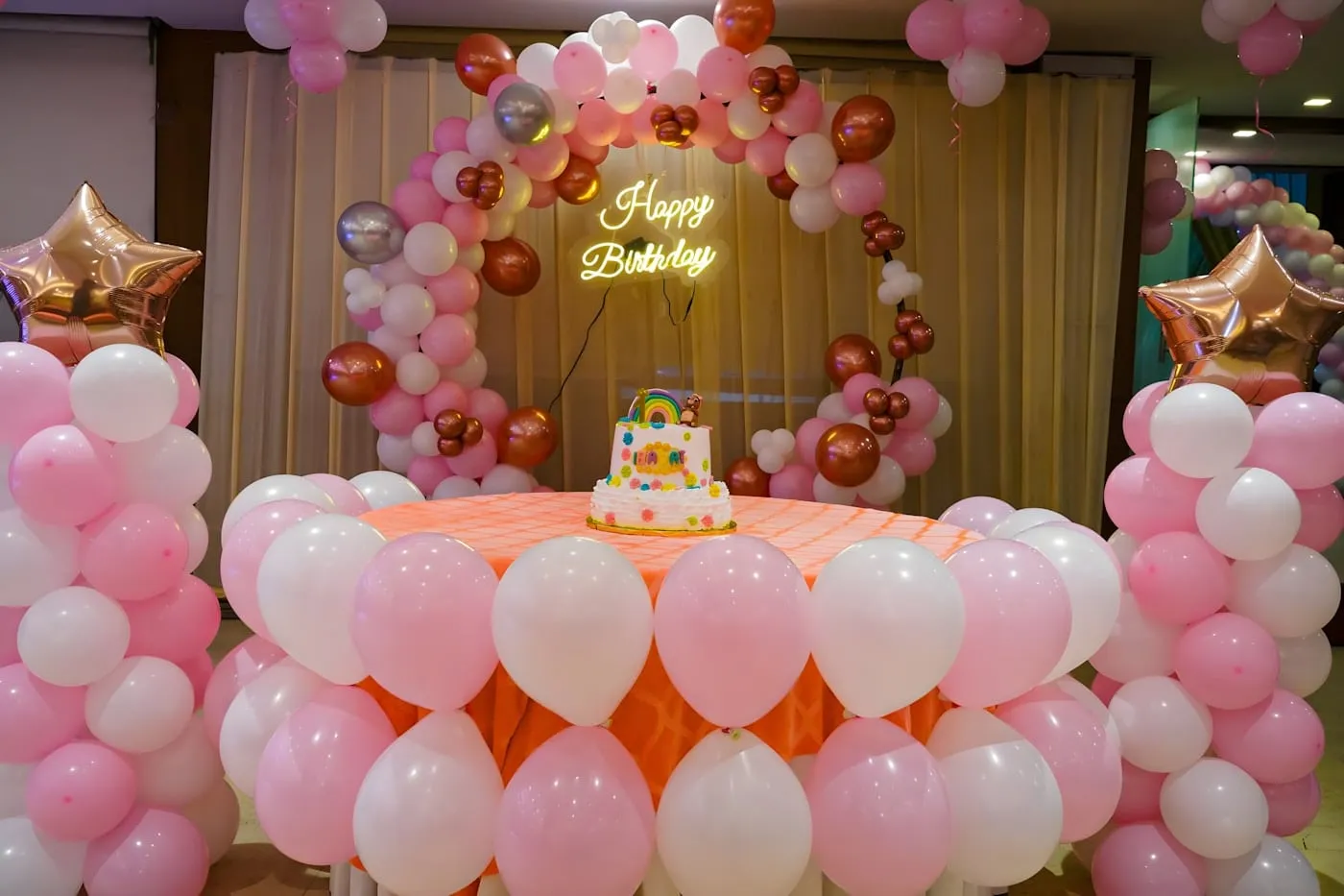 Decorated cake table with balloons