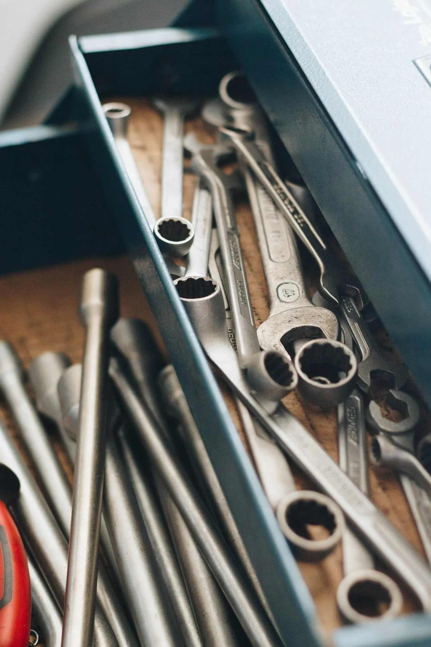 Machine parts and spanners on a workbench
